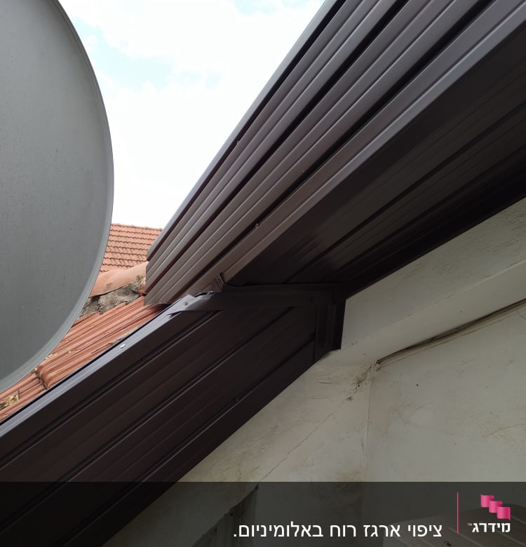 גג מתכת חום עם צלחת לוויין בצד